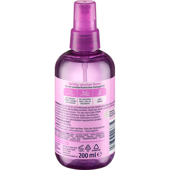 Transparente 200 ml Sprühflasche Balea Glattspray in Violett mit pinkem Etikett und Anwendungshinweisen auf der Rückseite.