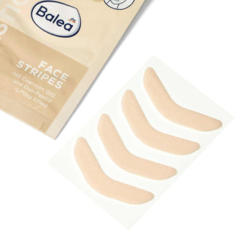 Vier hautfarbene, elastische Balea Face Stripes Lifting-Patches auf einer Trägerfolie neben der beigen Produktverpackung.